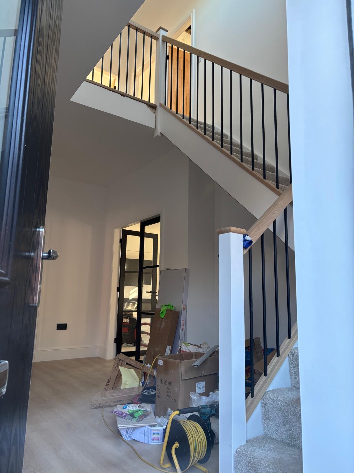 Oak staircase with black spindles fitted by DMC Joinery